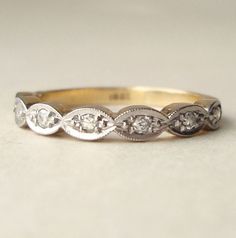 an antique style wedding ring with three diamonds