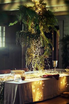 the table is covered with lights and greenery