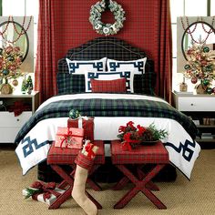 a bedroom decorated for christmas with presents on the bed