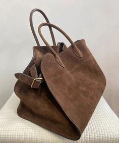 The exquisitely designed 2024 Brown Handbag offers unparalleled spaciousness and sophistication, making it the perfect accessory for the discerning individual.This bag is made of fine Faux Suede fabric.Measurement: 27cm/10.53" * 39cm/15.21" * 25cm/9.75"Zip up closure. Inside pockets. Luxury Solid Shoulder Bag, Luxury Solid Color Shoulder Bag, Luxury Solid Color Bags With Double Handle, Luxury Solid Color Office Shoulder Bag, Luxury Solid Color Double Handle Bag, Luxury Large Capacity Satchel For Daily Use, Chic Suede Shopping Bag, Luxury Suede Satchel For Daily Use, Chic Suede Satchel With Double Handle