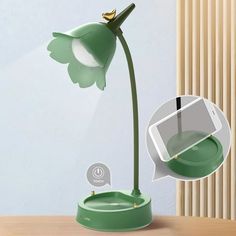 an image of a green flower on a table with a cell phone in the background