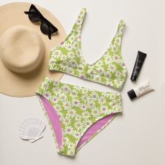 Perfect for the beach or laying by the pool, this retro floral daisy high waisted two piece bikini swimwear set features an adorable white daisy pattern on a lime green background with an accent pink inner liner. Designed in Cincinnati, Ohio, USA. Original artwork illustrated by Periwink Boutique. Made with a wink and a smile ;) This bikini is destined to become the only swimsuit you want to reach for in your drawer! The bottoms are high-waisted, and the top has removable pads. Both come with a Retro Green Swimwear For The Beach, Retro Swimwear For Beach Season Swimming, Retro Tankini For Beach Season And Pool, Retro Tankini For Beach Season, Retro Tankini For Pool And Beach Season, Retro Printed Swimwear For Beach Season, Green Retro Triangle Top Swimwear, Retro Swimwear For Beach Party Season, Retro Swimwear For Beach Party