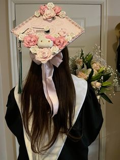 a woman wearing a graduation cap with flowers on it