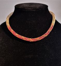 Handwoven Viking knit  double weave necklace in gold lacquered copper wire, with a long beaded section in the center of the chain.  Seed beads are fulle woven into the chain in red and orange in a spiral to create a thick colorful beaded insert.  Closed with a spring ring clasp in unknown metal.  The clasp can be swapped out on request for a magnetic or  gold one ($10 upcharge).    Viking knit is a wire weaving technique that creates a chain by looping wire back through itself, almost like crochet.  It is woven around a dowl rod, then removed and pulled through smaller and smaller holes in a draw plate to create a thin and flexible chain.  The weave on this piece is left open with a hollow center, and can be crushed.  I recommend storing it in a sealed box to prevent damage.  Viking knit i Wire Weaving Techniques, Viking Knit, Double Weave, Woven Necklace, Red And Orange, Wire Weaving, Silver Spring, Lovely Earrings, Wire Work