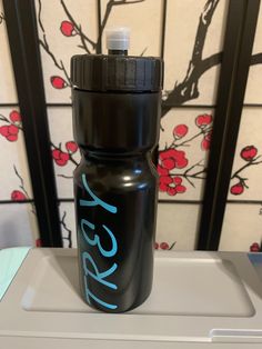 a black water bottle sitting on top of a counter