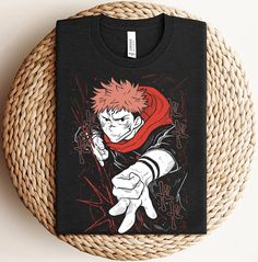 a black t - shirt with an image of the character naruto pointing his finger