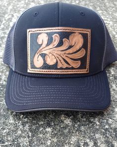 Black hat with hand carved leather patch. Ready to ship. Western Trucker Hat With Flat Bill For Country Events, Western Flat Bill Trucker Hat For Country Events, Western Style Trucker Hat For Country Events, Western Trucker Hat With Leather Patch, Western Style Adjustable Trucker Hat With Leather Patch, Western Style Brown Trucker Hat With Flat Bill, Western Brown Trucker Hat With Flat Bill, Western Black Snapback Hat For Rodeo, Western Trucker Hat With Leather Patch For Outdoor