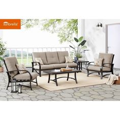 an outdoor patio furniture set with beige cushions