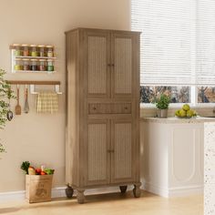 a tall cabinet in the corner of a kitchen