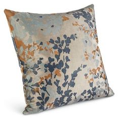 a blue and orange floral pillow on a white background