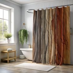 a bath room with a tub and a shower curtain that has different colored rocks on it