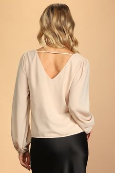 The Lulus Stylish and Sincere Beige Long Sleeve V-Neck Top is always serious when it comes to staying chic! Lightweight woven fabric shapes a V-neckline and back (with a strappy detail), plus a wide-cut boxy bodice. Long sleeves have gathering at the shoulders and elastic cuffs. Fit: This garment fits true to size. Length: Size medium measures 23.25" from shoulder to hem. Bust: Great for any cup size. Waist: Not Fitted - comfortable room throughout midsection. Undergarments: May be worn with any Chic V-neck Top With Notched Neckline For Spring, Versatile Beige V-neck Blouse, Chic V-neck Top For Spring Party, Chic V-neck Top For Brunch In Spring, Chic V-neck Top For Workwear, Chic V-neck Blouse For Date Night, Chic Spring Tops With Cutout Back, Chic Long Sleeve V-neck Top For Brunch, Elegant Fitted Top With Cutout Back