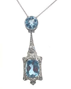 Introducing our exquisite Vintage Aquarium necklace, a true masterpiece of elegance and sophistication. This antique-inspired piece features a stunning combination of 2 Aqua stones totaling 12.70 carats and 6 carats, all encased in lustrous platinum. Exquisite Gemstone Diamond Necklace For Formal Occasions, Exquisite Gemstone Diamond Necklace For Formal Events, Formal Platinum Necklace With Rose Cut Diamonds, Formal Art Deco Diamond Necklace With Accents, Oval Diamond Necklace With Intricate Design, Formal Blue Necklace With Rose Cut Diamonds, Luxury Oval Necklace With Intricate Design, Art Deco White Gold Gemstone Necklace, White Gold Art Deco Gemstone Necklace