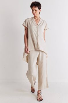 This unique tunic style top is tee shaped at the front and long and blouse shaped at the back. The floaty high low silhouette will add a flirty and feminine touch to any outfit. Pair with your favorite linen pants and sandals. Curved Hem Tops For Daywear In Spring, Beige Linen Lagenlook Top, Chic Linen Tops With Shirttail Hem, Linen Blouse With Shirttail Hem For Day Out, Versatile Summer Tunic With Relaxed Fit, Summer Tunic With Shirttail Hem For Daywear, Summer Tunic With Relaxed Fit And Shirttail Hem, Summer Tunic With Relaxed Fit, Summer Daywear Tops With Curved Hem