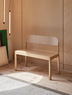 a wooden bench sitting on top of a hard wood floor next to a painting and lamp