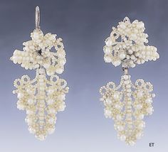 Presented is a lovely pair of Victorian seed pearl bridal earrings. These pieces date to around the 1850-1870 and are of American make. The earrings have 10 karat gold backs, for pierced ears. The earrings consist of seed pearls with larger round pearls sewn onto a mother-of-pearl backing, forming a design of a cluster of grapes. Seed pearl jewelry in this delicate, hand-sewn style was often made and worn specifically as bridal jewelry for a wedding, and this suite would be a lovely addition to Traditional Wedding Earrings With Historical Design, Traditional Earrings With Historical Design For Wedding, Traditional Historical Design Earrings For Wedding, Antique Wedding Earrings With Historical Design, Ornate Historical Wedding Earrings, Ornate Historical Design Earrings For Wedding, Vintage Historical Design Earrings For Wedding, Victorian Jewelry With Historical Design For Evening, Victorian Baroque Earrings For Formal Occasions