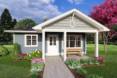 a small house with flowers around it and a bench in the front yard next to it