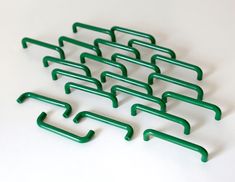 several green handles are arranged on a white surface