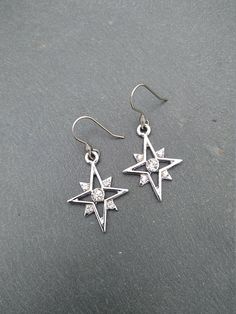 PLEASE read my shop announcement before placing an order so you know what to expect right now. Plus, when ordering from outside Europe, don't forget to provide a phone number for the courier to ensure the fastest and smoothest delivery. Elegant dangle rhinestone starburst earrings, comfortable and lightweight Stainless steel earhooks Stainless steel hooks, won't rust, change its tone or cause you any allergies More Magical celestial jewelry here: https://www.etsy.com/shop/ValkyriesSong?ref=selle Cubic Zirconia Star Charm Dangle Jewelry, Cubic Zirconia Dangle Jewelry With Star Charm, Celestial Silver Earrings With Star Charm, Sparkling Silver Starburst Jewelry, Star-shaped Cubic Zirconia Jewelry With Matching Earrings, Cubic Zirconia Drop Earrings With Star Charm, Pierced Star-shaped Metal Jewelry, Pierced Metal Star Jewelry, Star Charm Metal Drop Earrings