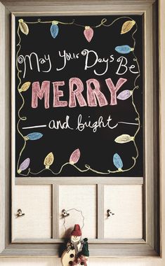 a framed chalkboard with the words merry and bright written on it next to a teddy bear