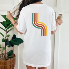 Classic unisex short sleeve tee made of soft cotton with quality "Groovy" pocket print on front, and retro 70s style rainbow design on back in large print. Details: 🌉Ribbed knit collars  🌉Shoulders are tapered for a better fit  🌉Dual side seams to hold shape longer 🌉Made with 100% Airlume combed and ring-spun cotton, a lightweight fabric easy to layer, breathable 🌉Crew neckline adds a classic style perfect for accessorizing 🌉Tear-away label ✨Production and Shipping Processing is 1-2 day. F Retro Short Sleeve T-shirt With Graphic Print, Retro Cotton Short Sleeve Tops, Retro Crew Neck Cotton T-shirt, Graphic Tee With Crew Neck And Retro Print, Graphic Tee With Retro Print And Crew Neck, Graphic Tee T-shirt With Retro Print And Crew Neck, Cotton Graphic Tee With Retro Print, Casual Retro Print Crew Neck T-shirt, Casual Retro Print Relaxed Fit T-shirt