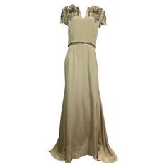 Naeem Kahn Heavily Embellished Champagne Silk Gown-Size 10 This spectacular Naeem Kahn creation is made of a wonderful champagne colored heavy silk and is lined in an additional layer of a lighter colored silk. The gown has a short cap sleeve and is heavily embellished in the upper are of the bodice front and back. The embellishment is made of a combination of multi sized and shaped sequin, paillettes and rhinestones that form a floral pattern. The gown has a rounded neckline with a small V down the center, fitted to the waistline where there is a 1” sequin/rhinestone detail and then the skirt goes out in an A line and has a fishtail in the back. There is a 23” back center zipper with a hook and eye closure in the top. This gown is in very good condition with only some minor wear as well a Formal Floral Embellished Floor-length Evening Dress, Luxury Hand Embellished Evening Dress For Wedding, Floor-length Floral Embellished Evening Dress, Floral Embellished Maxi Evening Dress For Wedding, Elegant Gown With Hand-embellished Fitted Bodice, Elegant Gown With Hand Embellished Fitted Bodice, Elegant Hand Embellished Gown With Fitted Bodice, Elegant Floor-length Hand Embellished Dress, Glamorous Silk Evening Dress For Wedding