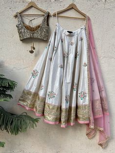 This beautiful off white raw silk lehenga with colourful sequins, stone and zardozi hand embroidery is paired with antique sequins blouse. This outfit is completed with a pink net dupatta with scallop edging with highlights. Peplum Lehenga, Colourful Embroidery, Sequins Blouse, White Lehenga, Raw Silk Lehenga, Dressing Ideas, Sequin Blouse, Indian Wedding Wear, Beautiful Dress Designs