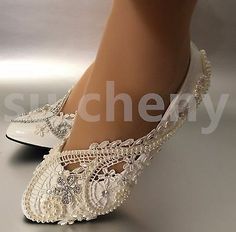 a woman's white shoes with pearls and lace