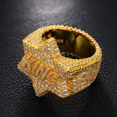 a gold ring that has been made out of yellow and white diamonds on top of it