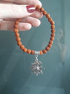 This unique bracelet with divine feminine vibes made of genuine small 5 Mukhi Rudraksha seeds beads and sun & moon charms.  You can wear this sacred beads bracelet in meditation and in your yoga practice, as well as in everyday life. You can wear this bracelet for protection, blessings, good fortune, health and well-being, and for spiritual evolution, or just because you like it :)  ! This bracelet is HANDMADE.  ! My Guru Pilot Babaji granted me the permission and blessing to make jewelry from Rudraksha for other people. ! Rudraksha that I use in my jewelry are high quality beads, real and genuine, from India. SYMBOLISM RUDRAKSHA in Sanskrit means "eye of Shiva" or "tears of Shiva". Rudra is one of the names of the Indian Lord Shiva. Rudraksha is known for its sacred and healing power: hea Spiritual Meditation Bracelets, Handmade Bohemian Bracelets For Meditation, Bohemian Handmade Bracelets For Meditation, Spiritual Round Beads Bracelets For Meditation, Handmade Spiritual Beaded Bracelets For Meditation, Spiritual Festival Bracelet With 108 Beads, Spiritual Round Beaded Bracelets For Festivals, Spiritual Festival Bracelets With 108 Beads, Spiritual Beaded Bracelets For Festivals