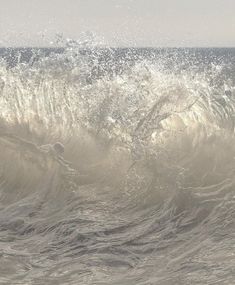 a man riding a wave on top of a surfboard