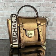 Michael Kors Manhattan Crossbody Satchel Bag 100% Authentic New With Tags Retail Price: $598.00 + Tax Gold-Tone Hardware 10"W X 7.25"H X 4"D Adjustable Strap: 19”-21” Exterior Details: Front Slip Pocket Interior Details: Back Zip Pocket, Front Slip Pocket Flip-Lock Fastening Shopping Bags With Gold-tone Hardware And Flap, Luxury Bag With Adjustable Strap And Flap, Designer Flap Bags With Adjustable Strap, Brown Top Handle Satchel With Metal Hardware, Luxury Brown Crossbody Satchel, Designer Cognac Satchel With Gold-tone Hardware, Designer Cognac Satchel With Detachable Handle, Designer Cognac Shoulder Bag, Modern Gold Satchel With Gold-tone Hardware