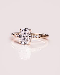 an engagement ring with a cushion cut diamond in the center