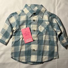 This New With Tags, Button Down Shirt Size 3-6 Months Is Adorable With A Blue And White Checkered Pattern, Buttons At The Elbows To Roll Up The Sleeves, And A Pleated Back. Ruggedbutts Is An Excellent Quality Clothing. Cute Blue Button-up Shirt, Cute Collared Shirt For Playtime, Fitted Tops With Buttons For Playtime, Cute Button-up Shirt For Playtime, Long Sleeve Shirt With Button Closure For Playtime, Blue Long Sleeve Shirt For Playtime, Cute Blue Button-up Top, Blue Tops With Buttons For Playtime, Cute Blue Collared Shirt