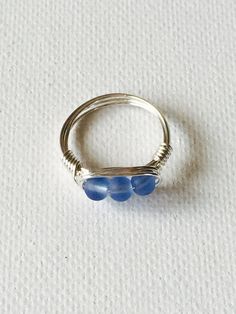 Triple Blue cultured sea glass silver plated wire wrapped ring. The silver plated wire is tarnish resistant And nickel and lead free. Beautiful blue colored glass to compliment any outfit. Made in Hawaii. Ships from Hawaii. The perfect gift for a loved one! This ring is a size 7 but one can be made in your size. Please specify size upon check out. Blue Sterling Silver Wire Wrapped Rings, Sea Glass Ring, Wire Wrapped Ring, Blue Sea Glass, Big Rings, Wire Wrapped Rings, Glass Rings, Wrap Rings, Silver Wire