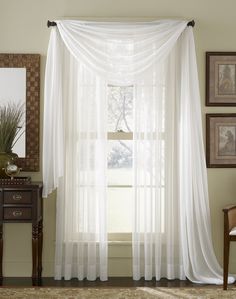 a white curtain hanging in front of a window