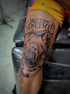 a man with a rose tattoo on his leg