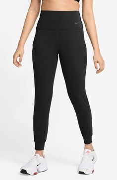 Legging-inspired joggers are made from soft fabric that you can feel with every bend or stretch, while moisture-wicking technology keeps you cool and comfy. 27 1/2" inseam; 8" leg opening; 13 1/2" front rise; 14" back rise (size Medium) Pull-on style Front slant pockets Lined gusset Dri-FIT moisture-wicking technology 63% nylon, 37% spandex Machine wash, line dry Imported Athleisure Joggers With 4-way Stretch And Elastic Side Panels, Moisture-wicking Elastane Pants For Jogging, Sporty Comfort Stretch Sweatpants, Sporty Stretch Elastane Joggers, Sporty Elastane Stretch Joggers, Casual Moisture-wicking Sweatpants, Athleisure Elastane Joggers For Sports, Black Comfort Stretch Joggers For Jogging, Black Comfort Stretch Joggers