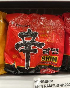 bags of shin noodles are on display in a grocery store's shelf for sale