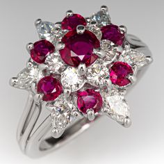 This beautiful ring is centered with a four-prong set, round cut ruby, surrounded by six (6) prong set, round brilliant cut diamonds. The top of the ring is accented with six (6) smaller, round mixed cut rubies and six (6) pear brilliant cut diamonds in prong settings. The ring measures 16.4mm at the top, rises 10.6mm above the finger, tapering to 1.4mm wide and 1.0mm thick at the base of the shank. This ring is currently a size 4.5. Luxury Red Cluster Diamond Ring, Luxury Red Cluster Ring, Red Cluster Diamond Ring With Brilliant Cut, Classic Red Cluster Ruby Ring, Classic Red Cluster Diamond Ring, Classic Red Ruby Cluster Ring, Elegant Red Ruby Cluster Ring, Red Diamond Cluster Ring With Vvs Clarity, Fine Jewelry Ruby Cluster Ring With Brilliant Cut