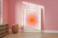 a pink room with a large poster on the wall and a vase next to it