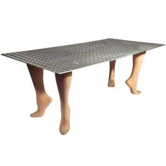 a wooden table with two legs that are made out of metal sheeting on top of it