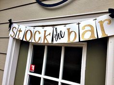 a sign that says stock the bar hanging from a window