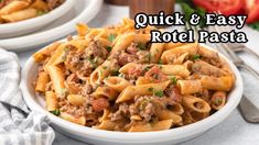 two white bowls filled with pasta and meat on top of a table next to tomatoes