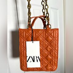 Z Ara Mini Leather Tote Bag Rust Orange Patterned Chain Bag Art: 6621/810/070 Length 6.5 Inches X Width 2.5 Inches X Height 7 Inches Rectangular Shoulder Bag With Branded Hardware As Gift, Box Shoulder Bag With Chain Strap For Shopping, Chain Strap Box Shoulder Bag For Shopping, Shoulder Box Bag With Chain Strap For Shopping, Square Satchel With Chain Strap For Shopping, Trendy Square Bag With Branded Hardware, Square Bags With Chain Strap For Shopping, Square Leather Bag With Chain Strap, Leather Square Bag With Chain Strap