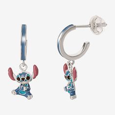 a pair of earrings with cartoon characters hanging from it's ends, on a white background