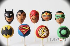 a group of cake pops with batman and superman masks on them