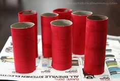 six red spools of thread sitting on top of a table next to each other