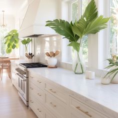 a kitchen filled with lots of white counter top space