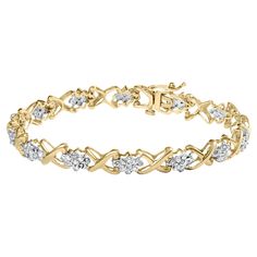 Introducing the perfect finishing touch for any sophisticated outfit - a stunning diamond bracelet. Crafted from lustrous 10K yellow gold plated .925 sterling silver, this bracelet boasts a dazzling array of round-cut diamonds totaling a breathtaking 2 carats. The diamonds are rated H-I in color and I2-I3 in clarity, ensuring a sparkling and eye-catching display. Featuring alternating links of diamond clusters and elegantly designed "x shaped links," this bracelet is sure to become a treasured addition to any jewelry collection. The bracelet measures 7 inches in length, fitting comfortably on wrists up to that size. The secure box with latch clasp ensures that this bracelet stays put, no matter where your day takes you. Whether dressing up for a special occasion or simply adding a touch of Bracelet Indian, Box Clasp, Diamond Settings, Yellow Gold Bracelet, Diamond Cluster, Round Cut Diamond, 10k Gold, White Diamond, Diamond White